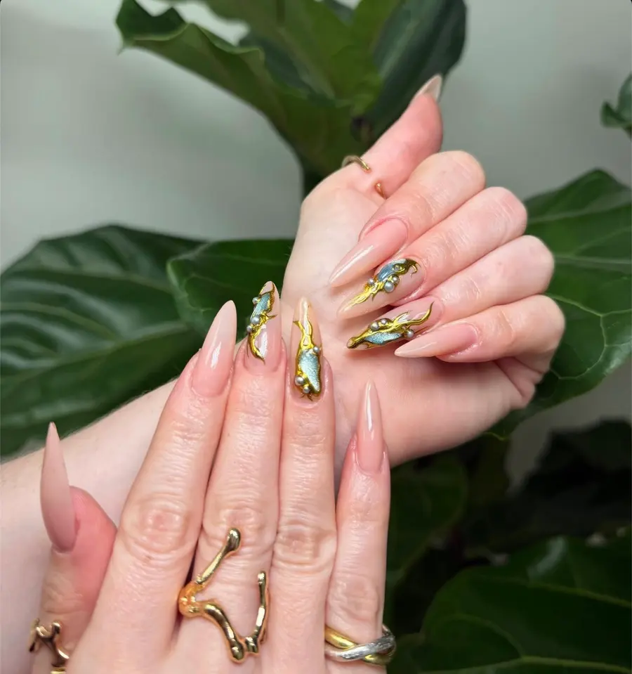 Uñas nude largas con chrome dorado, azul y perlas