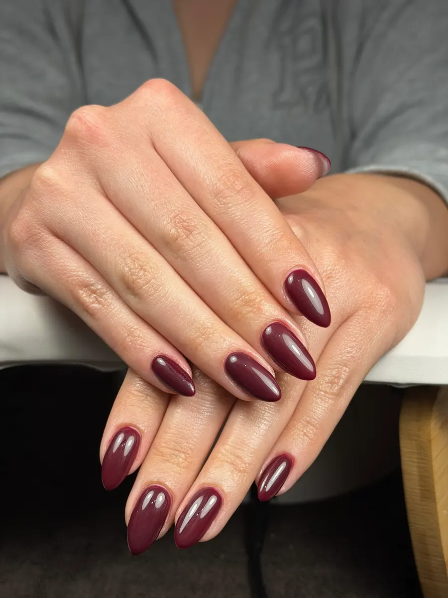 Manicure en gel color vino, forma almendra, con brillo intenso